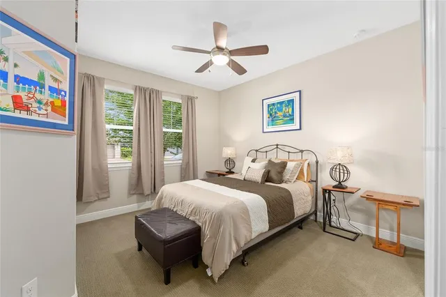 a bedroom with a bed and a painting on the wall