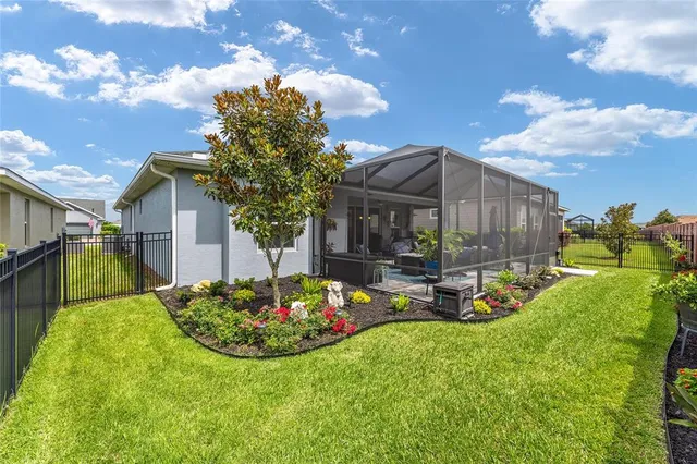 a view of a chair and table in backyard of the house