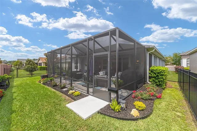 a view of a backyard with plants and a patio