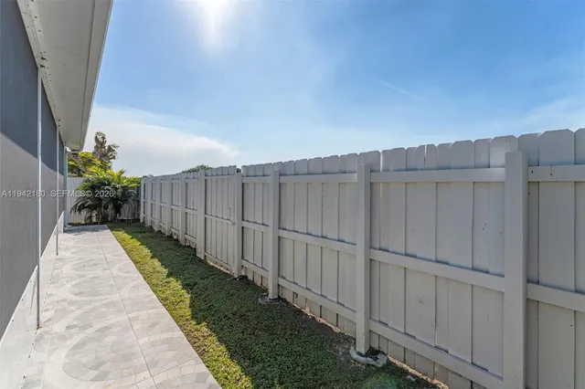 a view of a pathway with a wooden fence