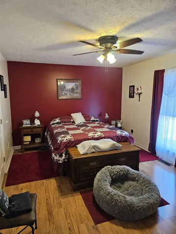 a bedroom with a bed and a mirror