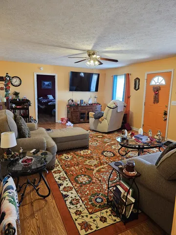 a living room with furniture and a chandelier