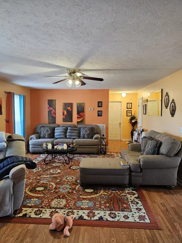 a living room with furniture and a chandelier