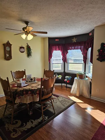 a living room with furniture a chandelier and a wooden floor