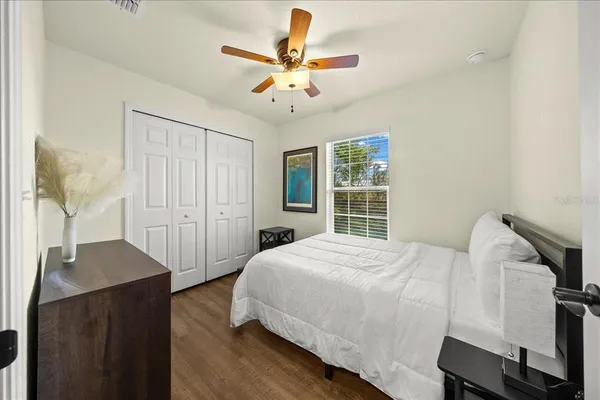 a bedroom with a bed and a chandelier