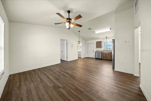 a kitchen with stainless steel appliances cabinets a sink and a oven