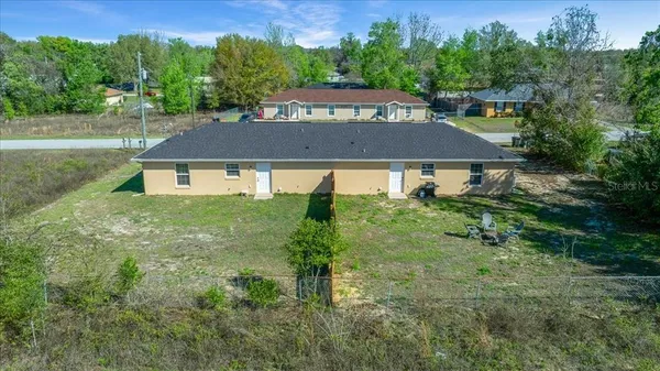 a view of a garden with a building in the background