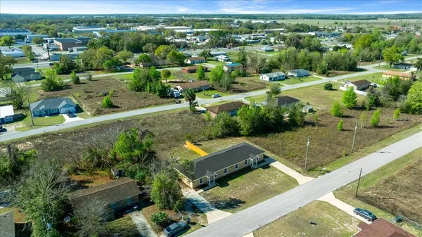 an aerial view of multiple houses with yard