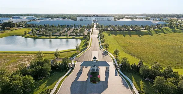 an aerial view of a residential houses with outdoor space and trees