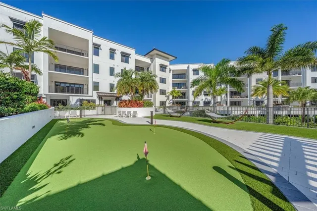 a swimming pool with outdoor seating and yard