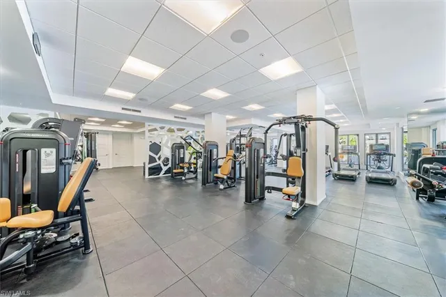 a living room with lots of furniture and a view of swimming pool