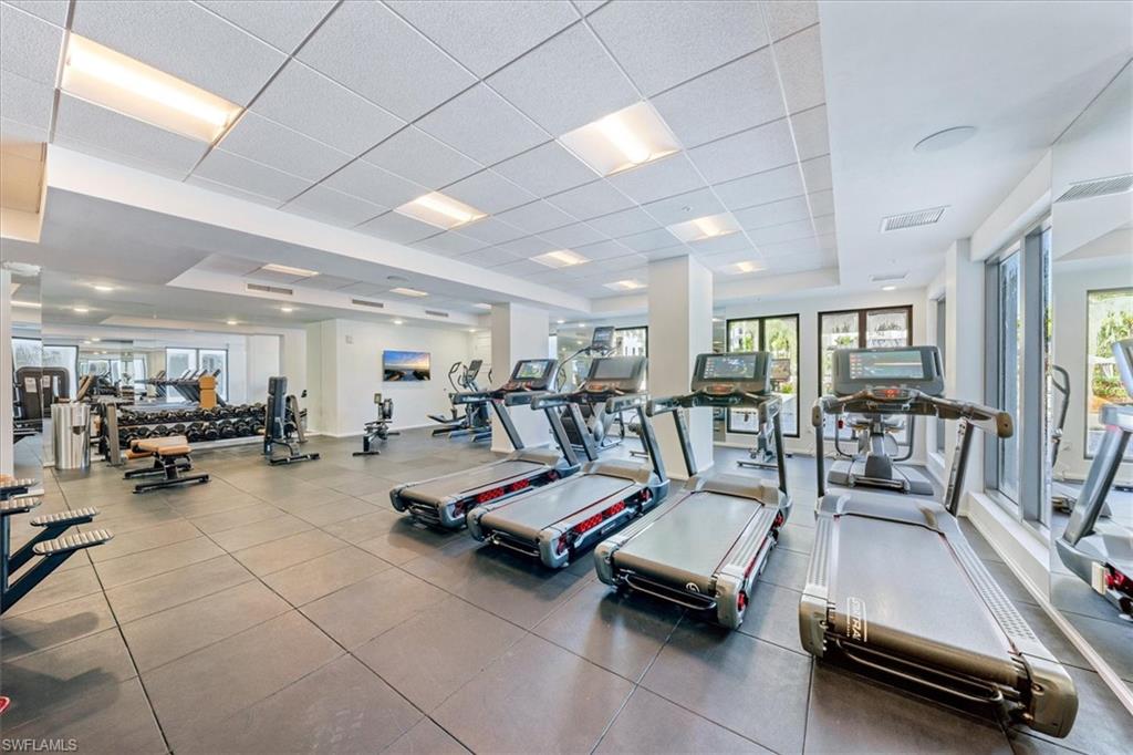 1115 Central Avenue, Unit 445 Naples, FL 34102 - Photo 19 of 20 a living room with lots of furniture and a view of swimming pool