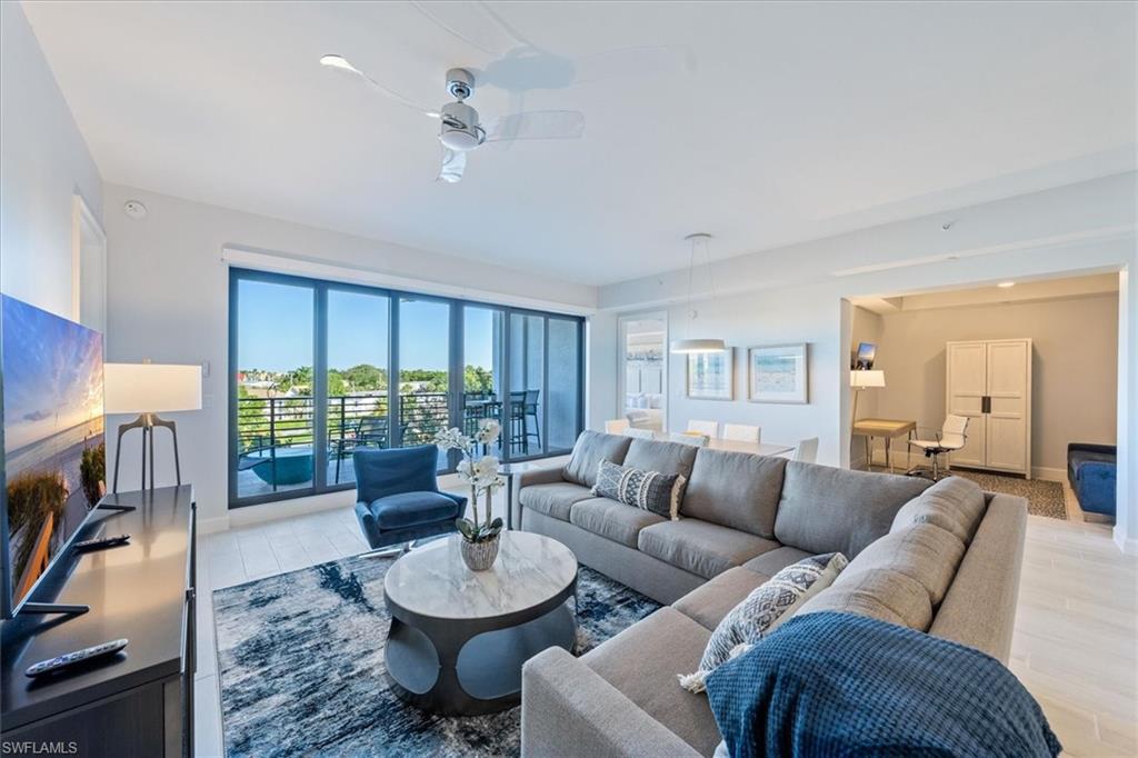 1115 Central Avenue, Unit 445 Naples, FL 34102 - Photo 2 of 20 a living room with furniture and a large window