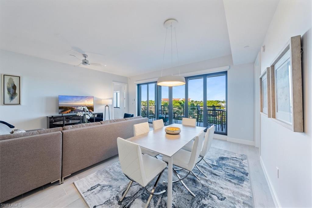 1115 Central Avenue, Unit 445 Naples, FL 34102 - Photo 6 of 20 a living room with furniture and a potted plant