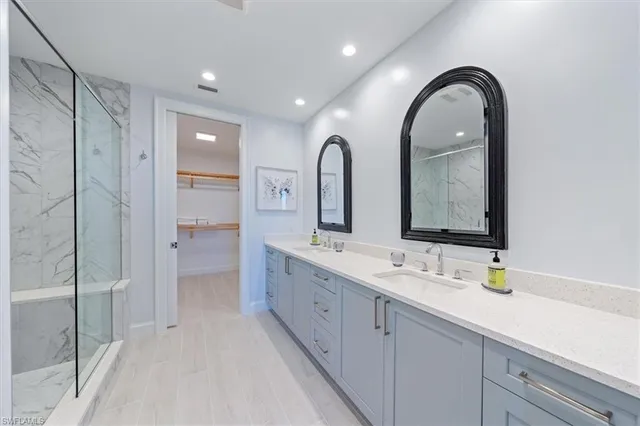 a spacious bathroom with a double vanity sink mirror and double