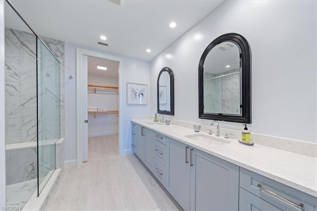 1115 Central Avenue, Unit 445 Naples, FL 34102 - Photo 8 of 20 a spacious bathroom with a double vanity sink mirror and double