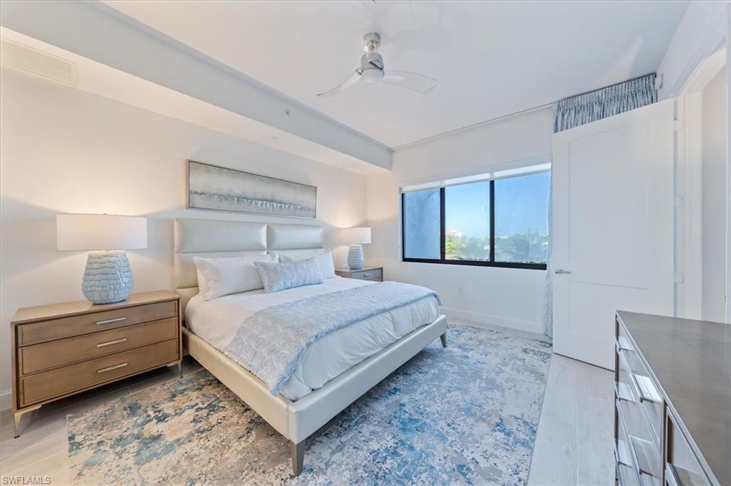 1115 Central Avenue, Unit 445 Naples, FL 34102 - Photo 9 of 20 a bedroom with a bed and a dresser