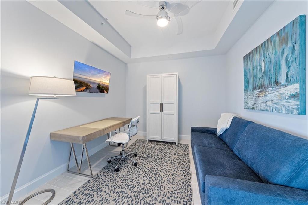 1115 Central Avenue, Unit 445 Naples, FL 34102 - Photo 10 of 20 a living room with a couch and a chandelier