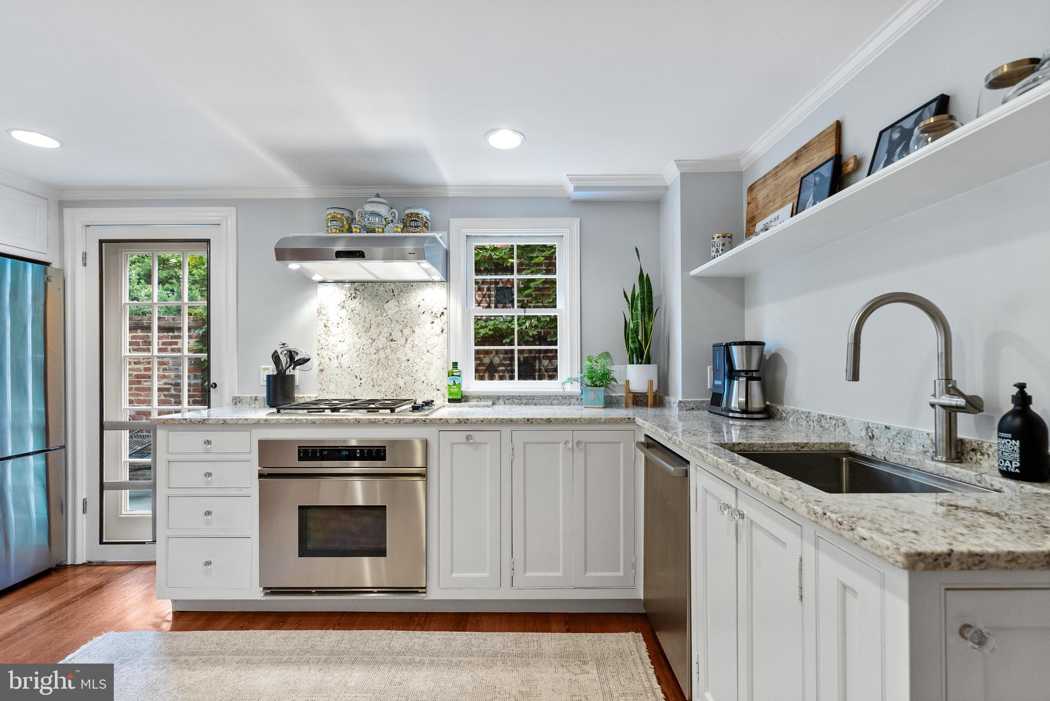3403 O Street Northwest Washington, DC 20007 - Photo 11 of 35 a kitchen with granite countertop a sink stainless steel appliances and window