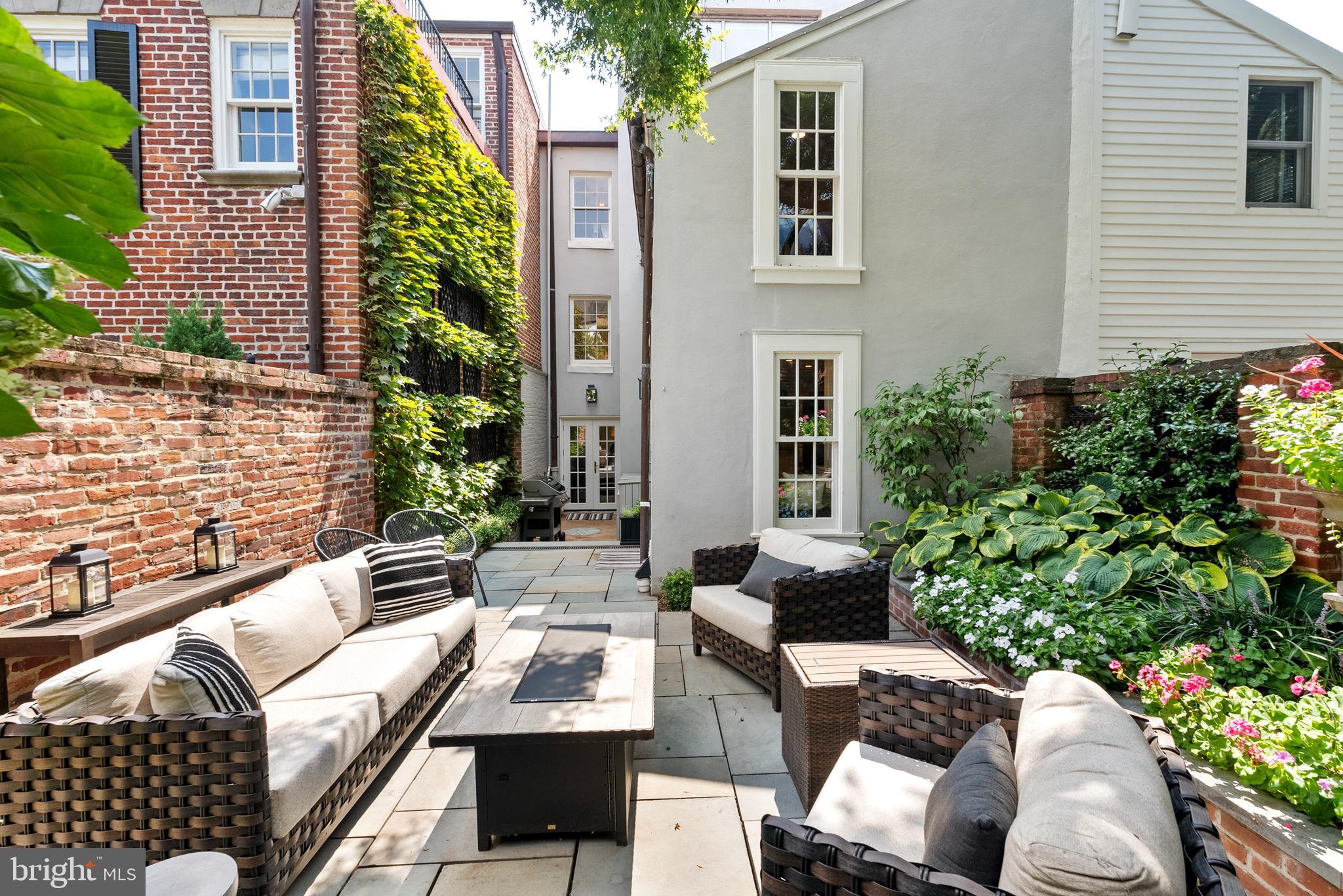 3403 O Street Northwest Washington, DC 20007 - Photo 15 of 35 a view of a patio with couches table and chairs and potted plants