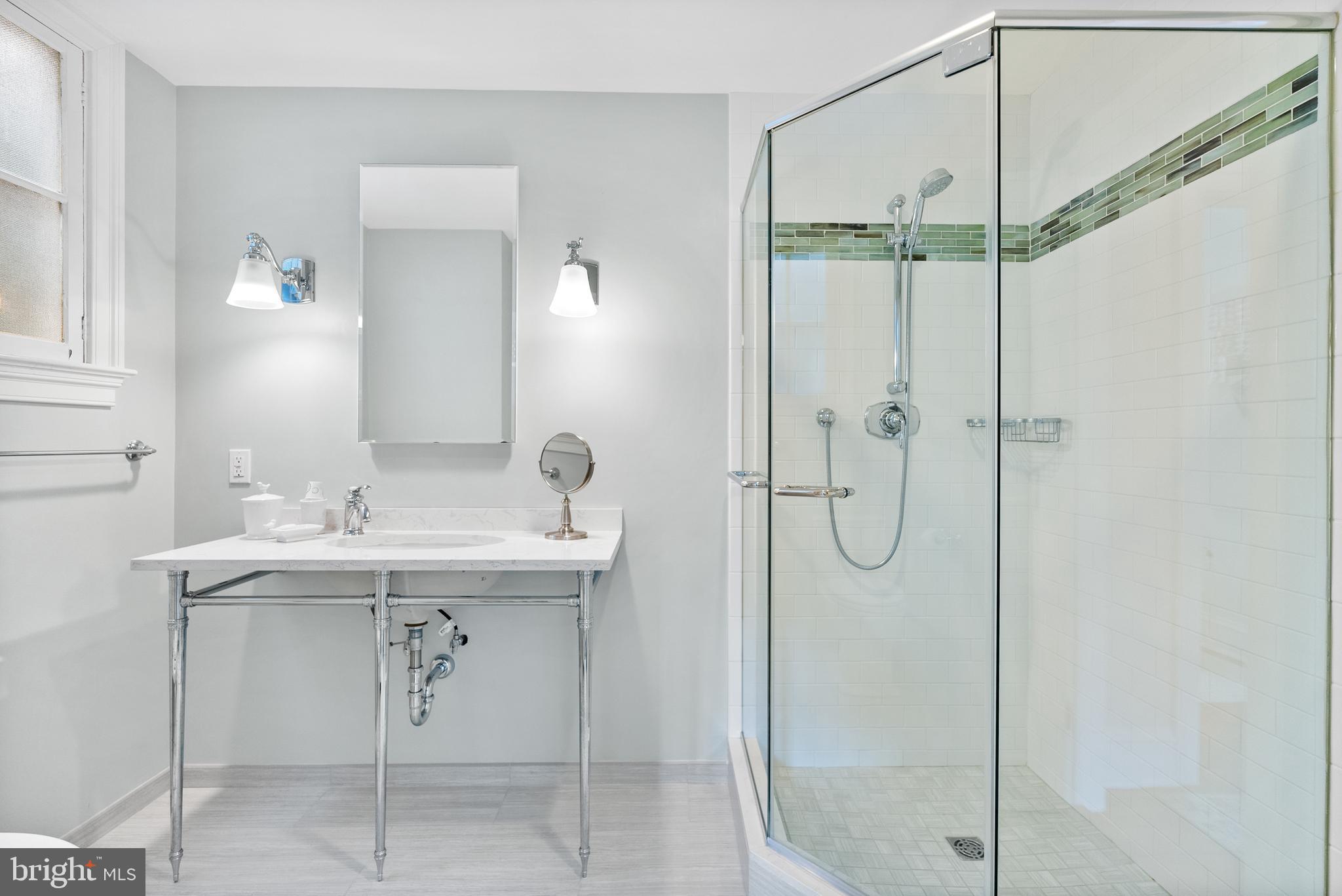 3403 O Street Northwest Washington, DC 20007 - Photo 27 of 35 a bathroom with a shower sink and mirror