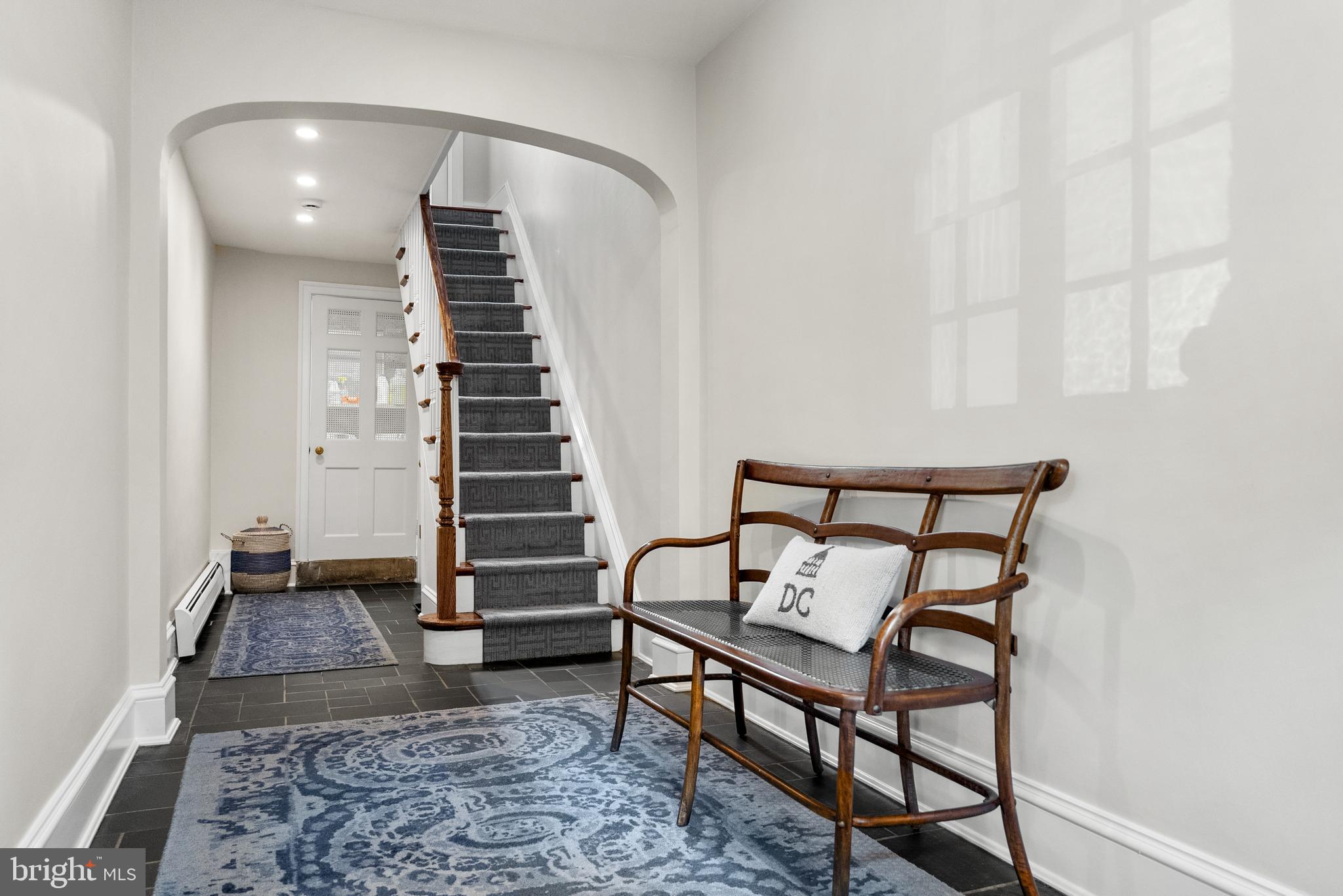 3403 O Street Northwest Washington, DC 20007 - Photo 5 of 35 a view of a hallway with stairs and wooden floor