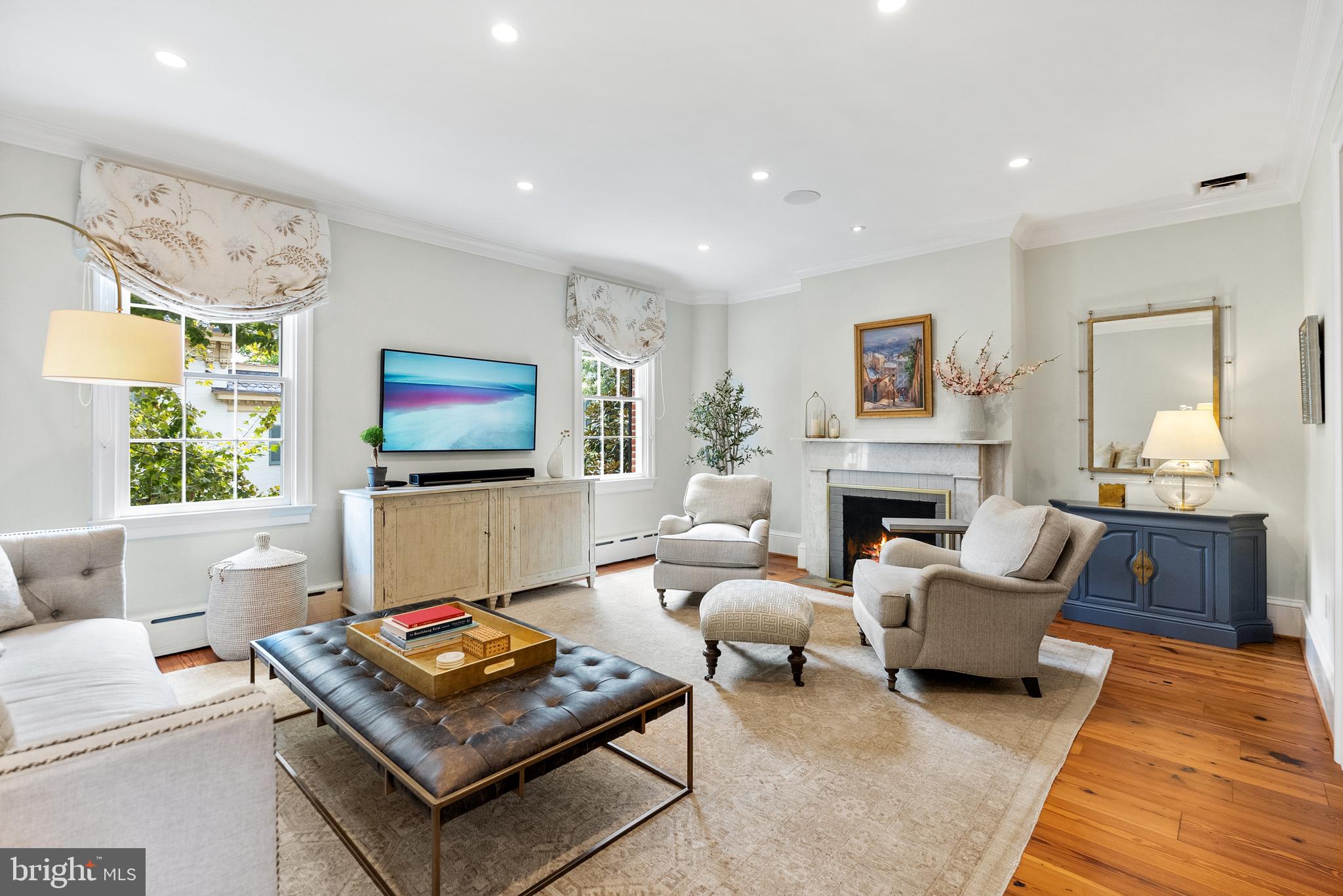 3403 O Street Northwest Washington, DC 20007 - Photo 6 of 35 a living room with furniture a flat screen tv and a fireplace