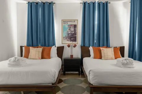 a bedroom with bed and a chandelier