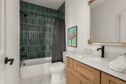 a bedroom with two beds and a potted plant