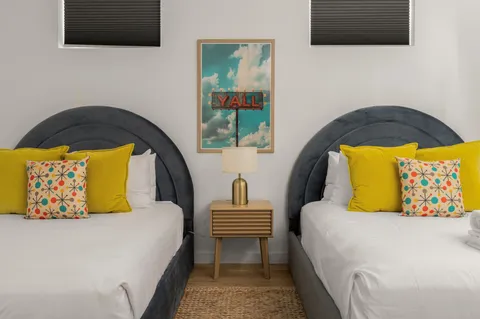 a kitchen with stainless steel appliances granite countertop a stove a sink dishwasher a refrigerator and a dining table with wooden floor