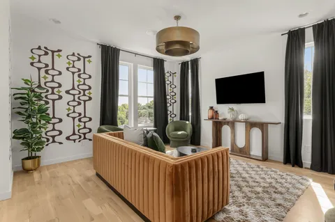 a bedroom with furniture and a flat screen tv