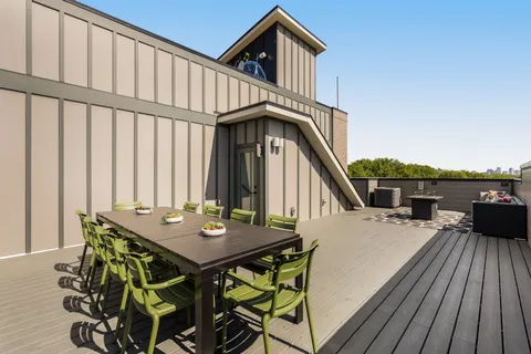 a balcony view with two chairs and wooden floor