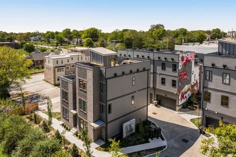 a view of a house with wooden fence