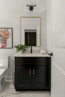 a bathroom with a toilet a sink and a mirror