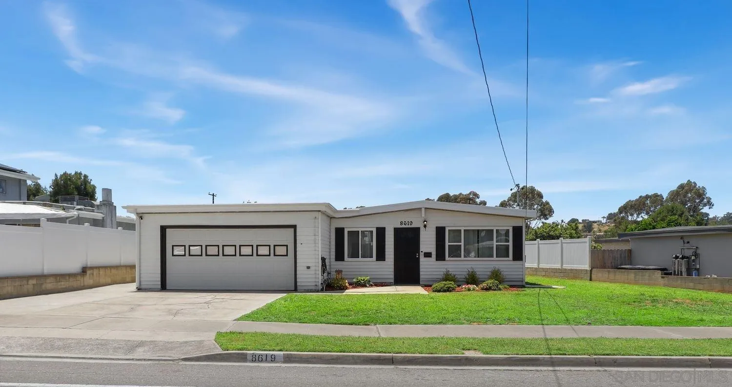 a view of a house next to a yard