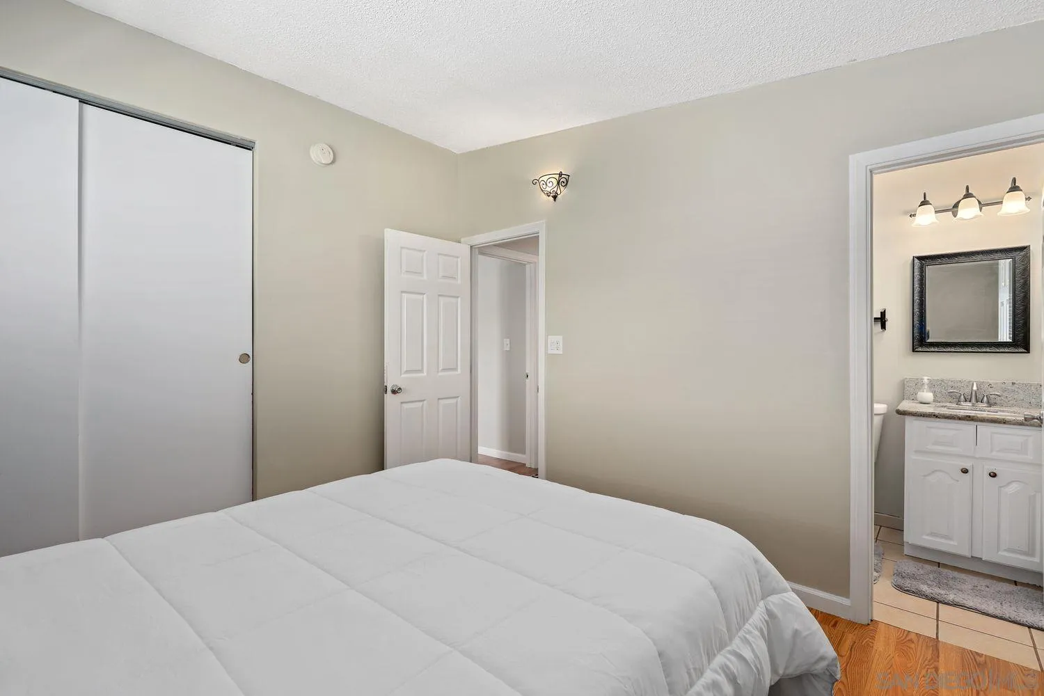 8619 Harness Street Spring Valley, CA 91977 - Photo 11 of 23 a bedroom with a bed and a flat tv screen on dresser