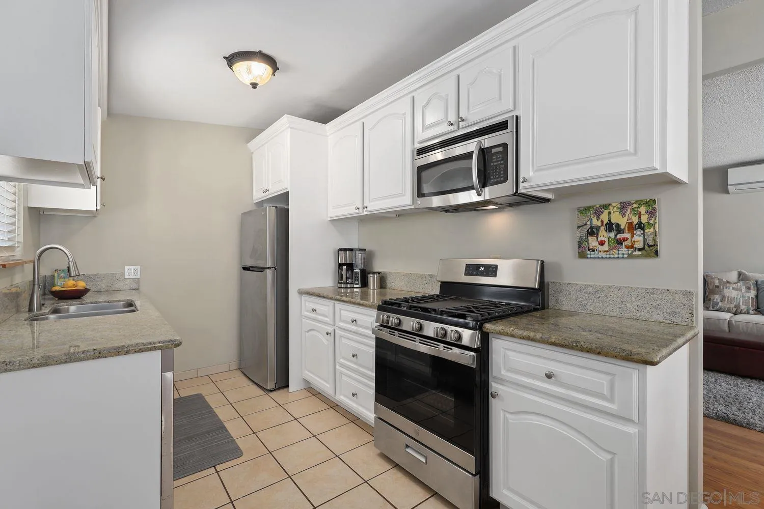 8619 Harness Street Spring Valley, CA 91977 - Photo 6 of 23 a kitchen with stainless steel appliances granite countertop a sink stove and refrigerator