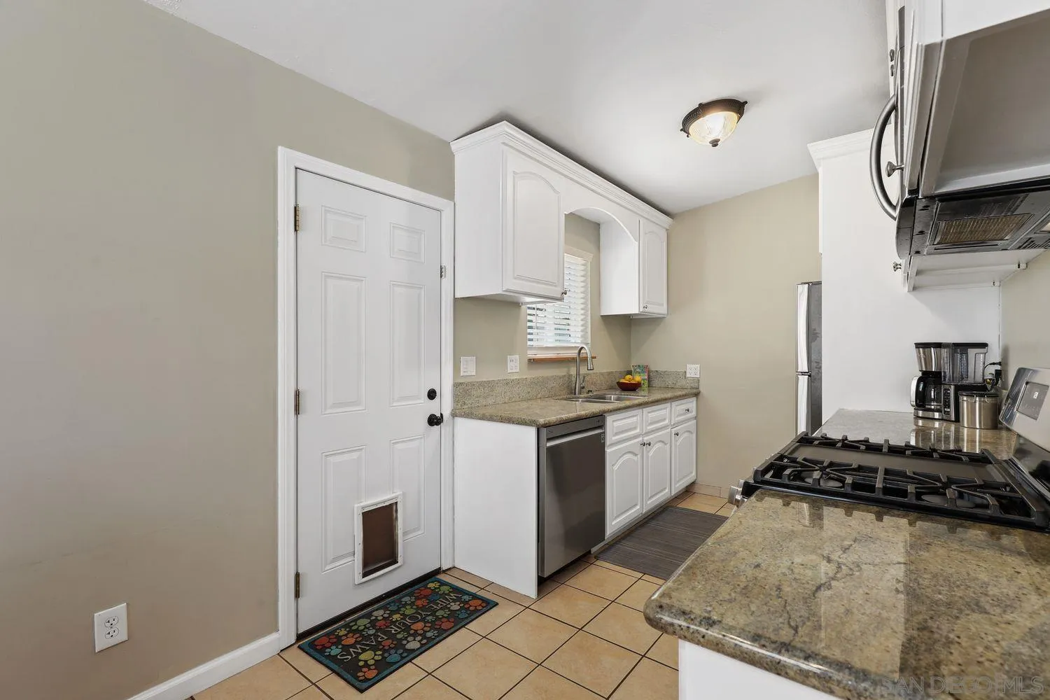 8619 Harness Street Spring Valley, CA 91977 - Photo 7 of 23 a kitchen with stainless steel appliances granite countertop a stove a sink and a refrigerator