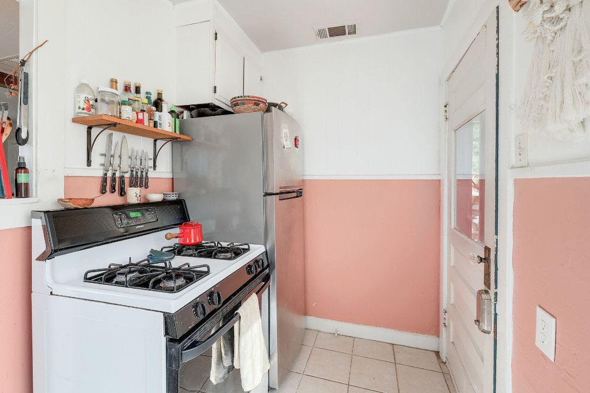 1006 East 44th Street Austin, TX 78751 - Photo 22 of 28 Kitchen with gas range and stainless steel refrigerator
