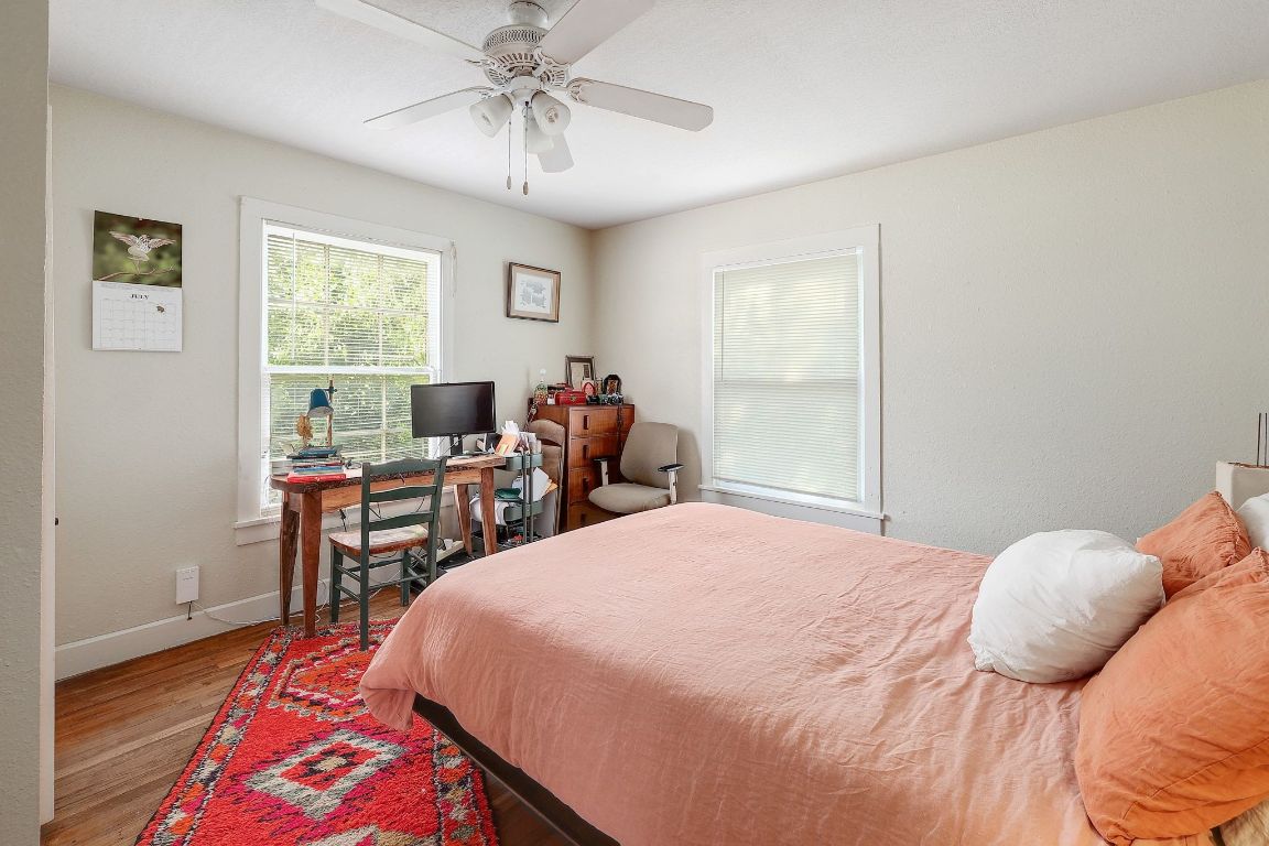 1006 East 44th Street Austin, TX 78751 - Photo 24 of 28 Primary bedroom with large windows and vintage hardwood floors