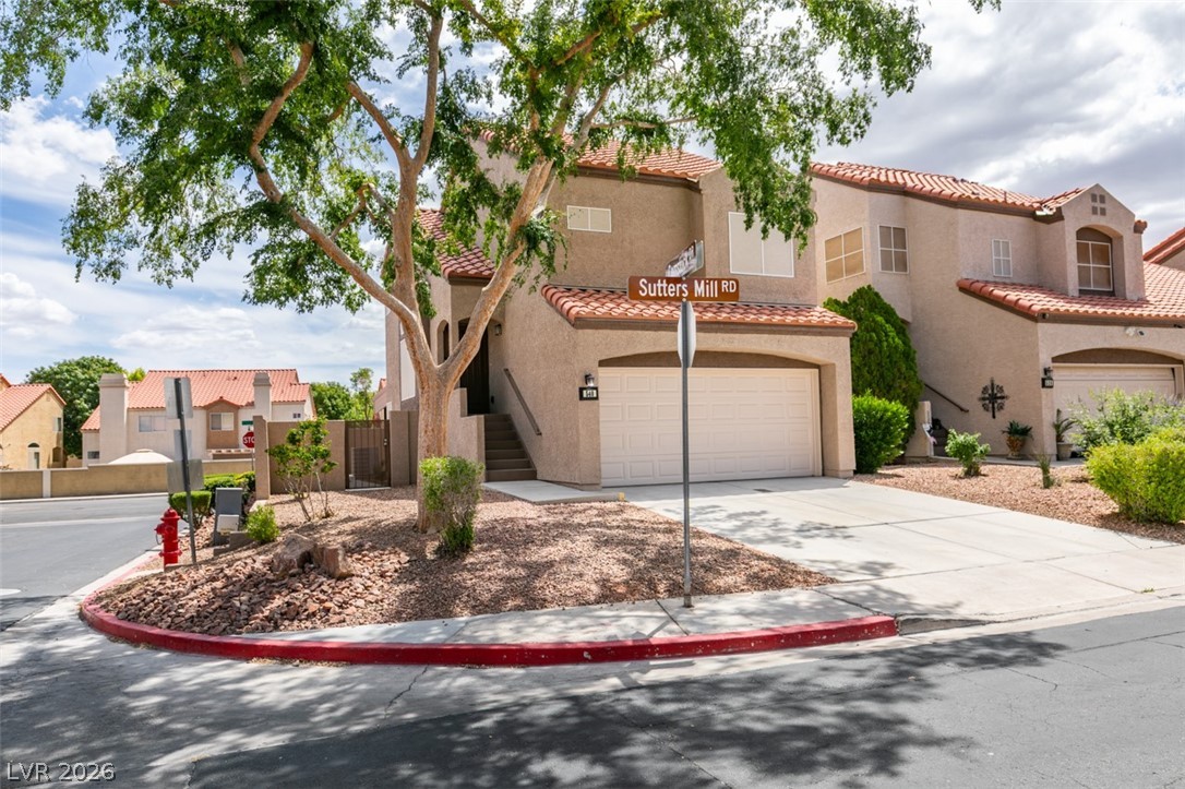 540 Sutters Mill Road Henderson, NV 89014 - Photo 7 of 46 This residence showcases a traditional stucco exterior with a tile roof and an attached garage.