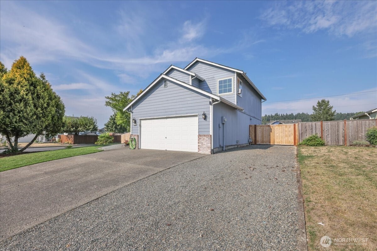322 Orting Avenue Northwest Orting, WA 98360 - Photo 1 of 36 a front view of a house with a yard and garage