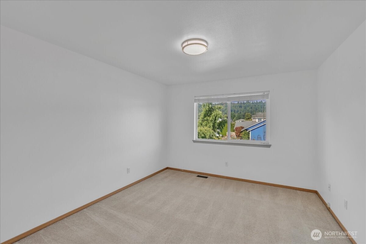 322 Orting Avenue Northwest Orting, WA 98360 - Photo 20 of 36 an empty room with windows