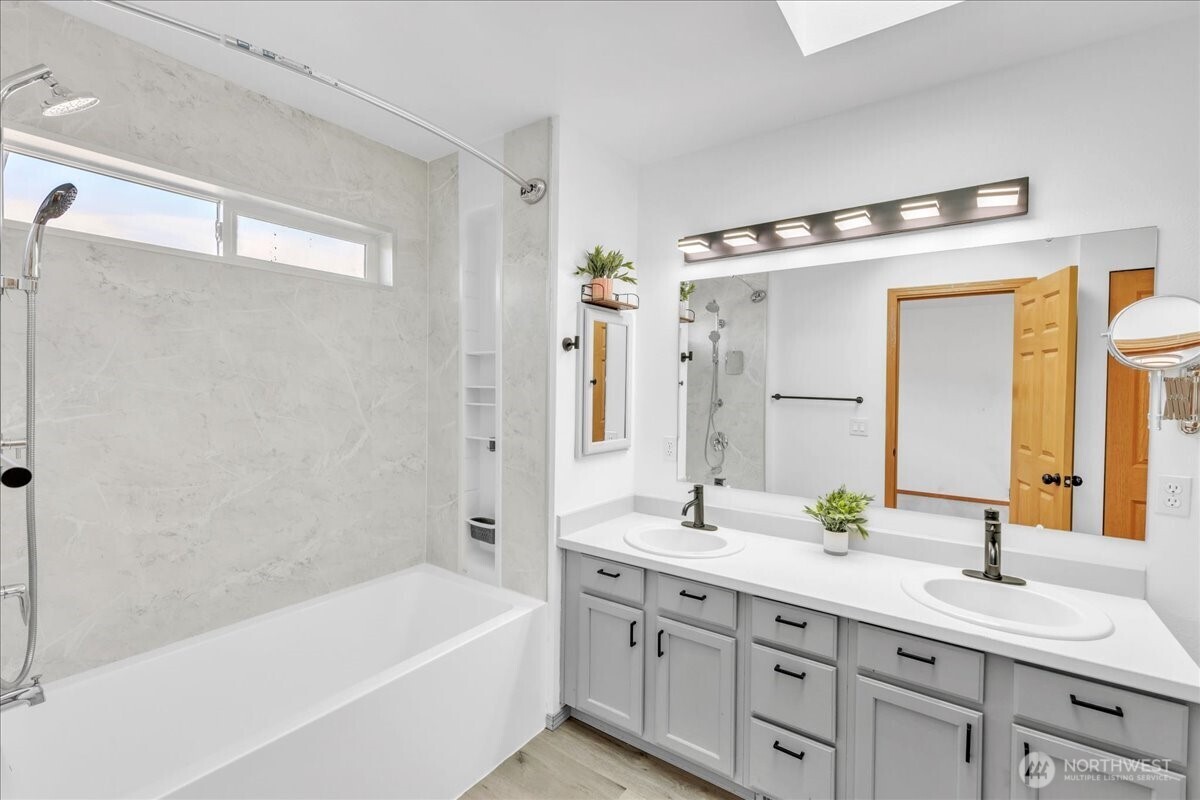 322 Orting Avenue Northwest Orting, WA 98360 - Photo 21 of 36 a bathroom with a tub a sink and mirror