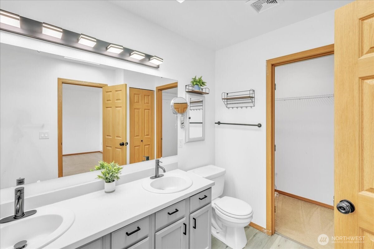 322 Orting Avenue Northwest Orting, WA 98360 - Photo 22 of 36 a bathroom with a granite countertop sink toilet and shower