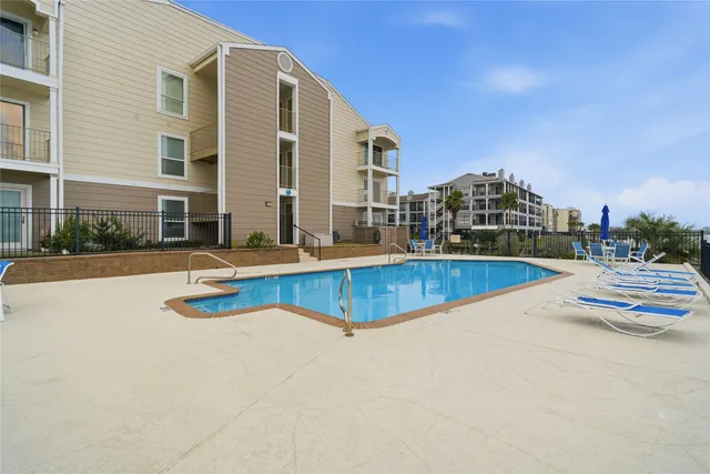 a view of residential building with outdoor space and lake view