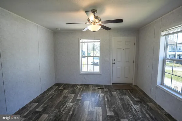 a kitchen with granite countertop a refrigerator stove and microwave