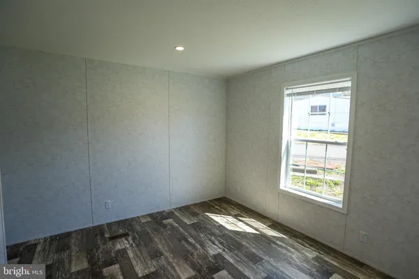 a view of a room with wooden floor and closet