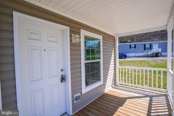 a view of a porch with wooden floor and fence