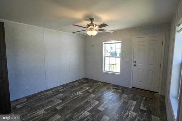 a kitchen with kitchen island a counter top space a refrigerator and a sink